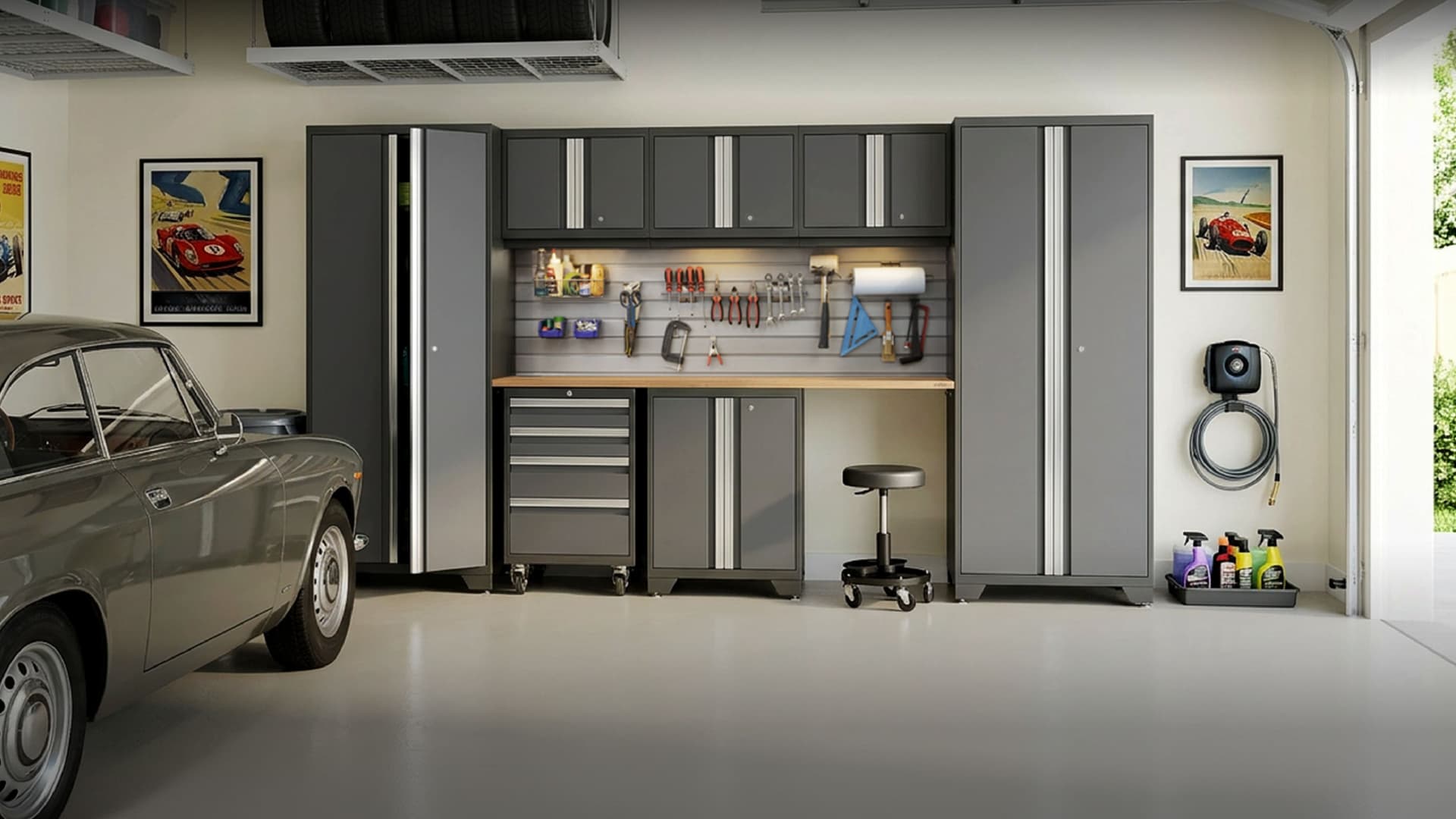 NewAge grey garage cabinets with a stainless-top workbench and an overhead tire rack