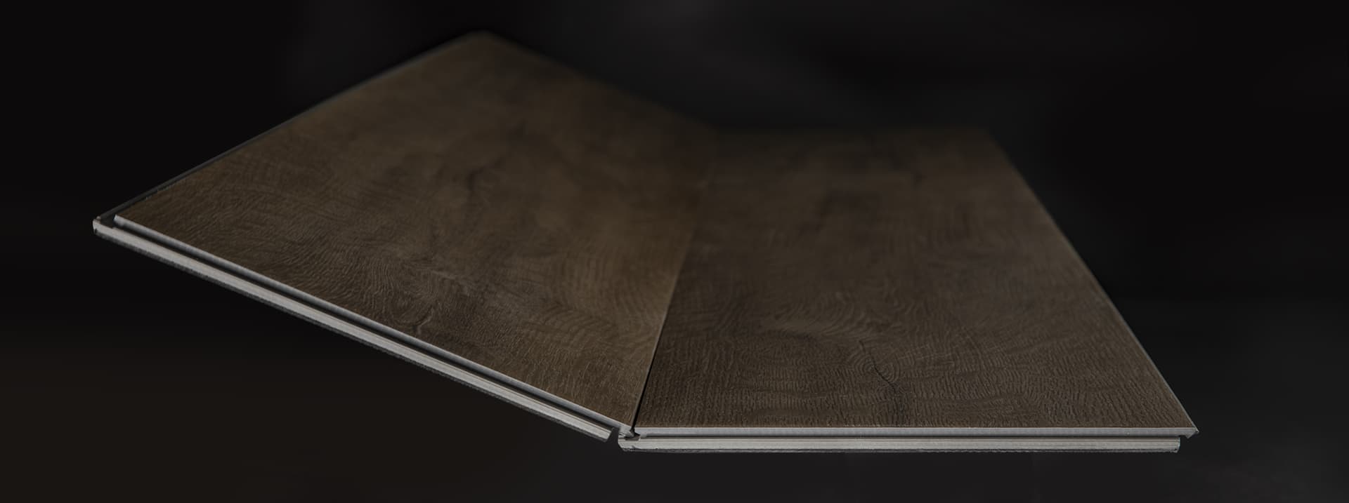 Close-up of a wood-look luxury vinyl plank floor showing the click-lock edge