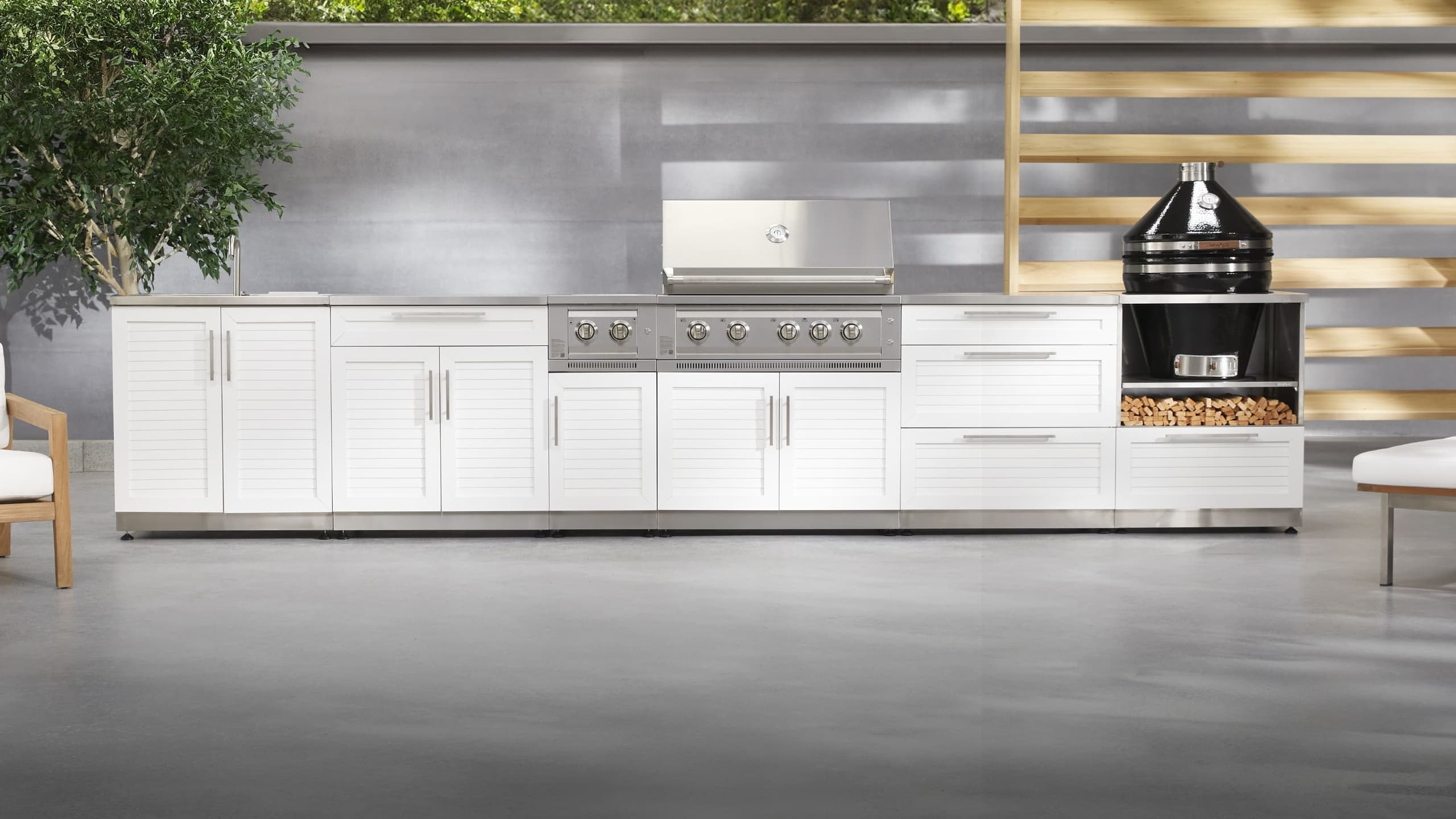 NewAge outdoor kitchen with stone-clad surrounds, a kamado grill and built-in gas grill