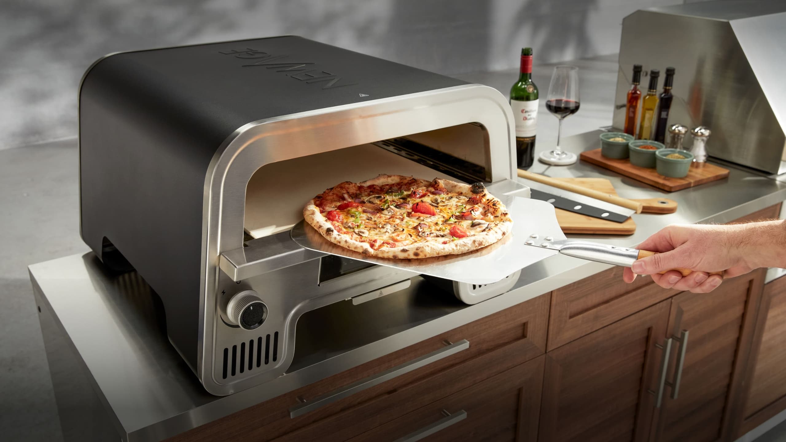 NewAge modular grill island with wood-look louvered doors, a built-in gas grill and sink