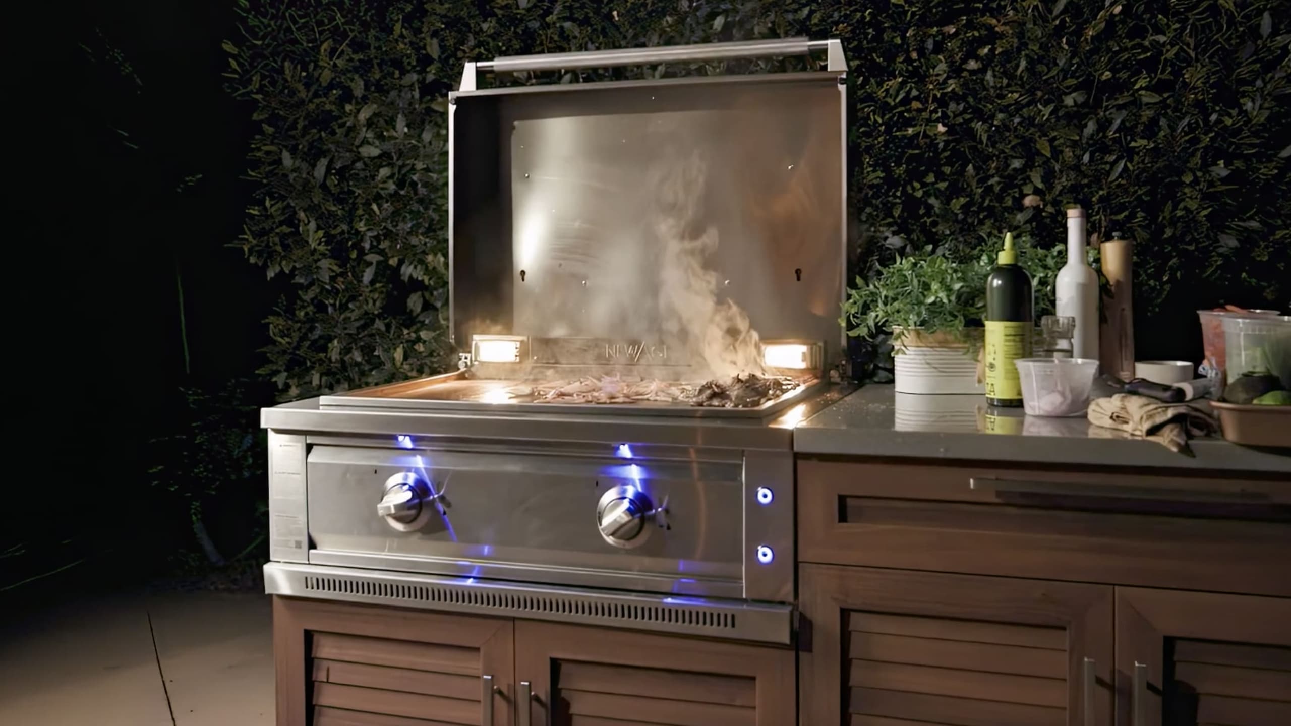 NewAge modular grill island with wood-look louvered doors, a built-in gas grill and sink