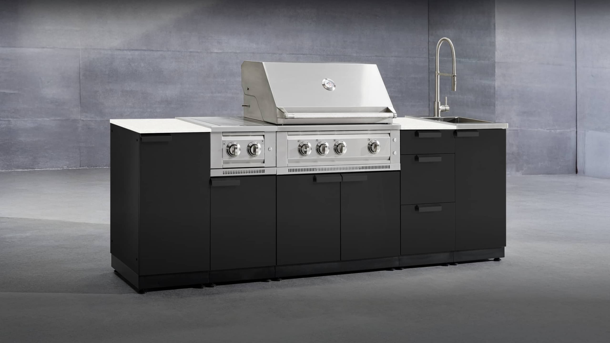 NewAge gloss black grill island with a white countertop, built-in gas grill and sink