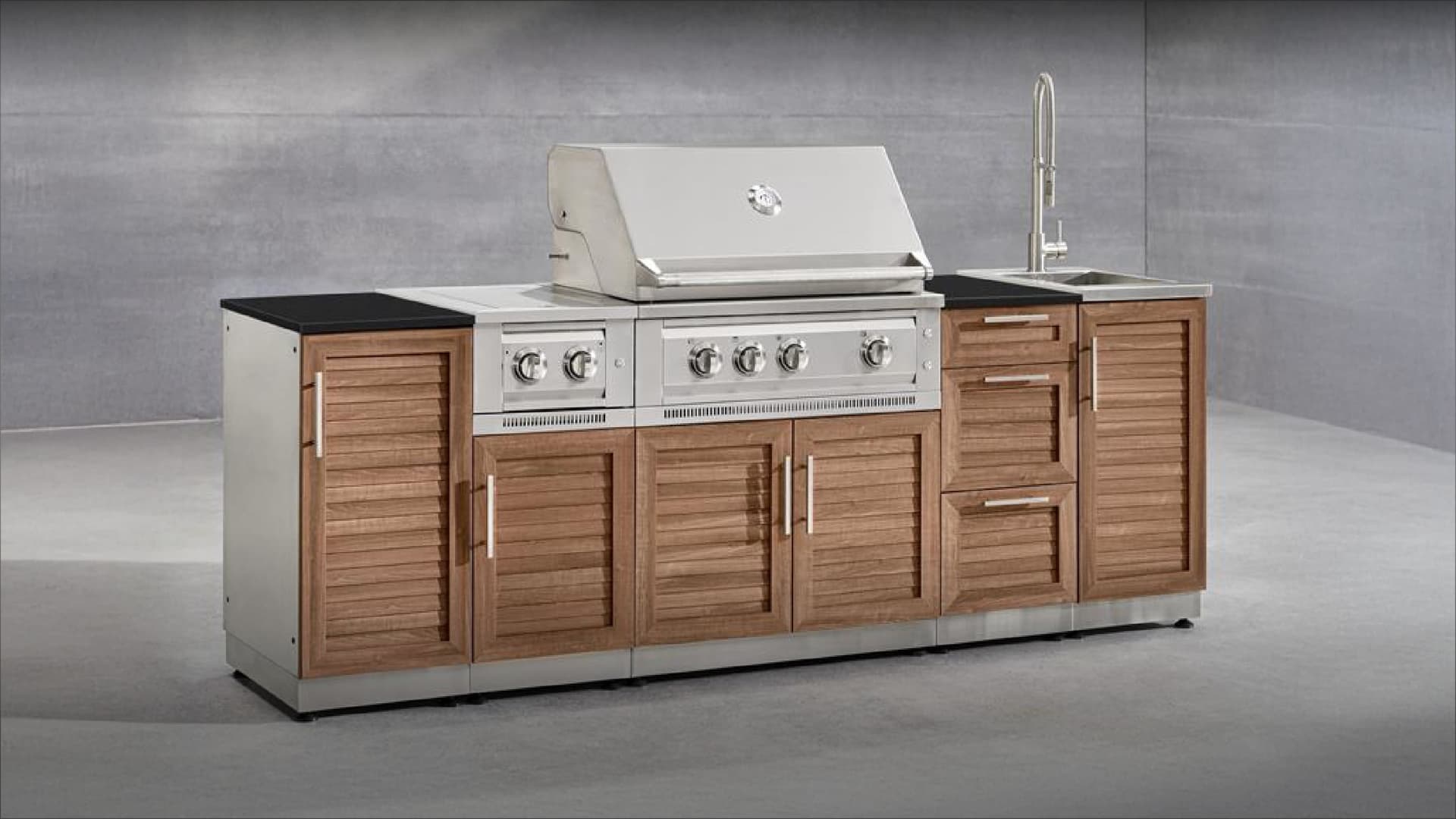 NewAge modular grill island with wood-look louvered doors, a black countertop, built-in gas grill, side burner and sink