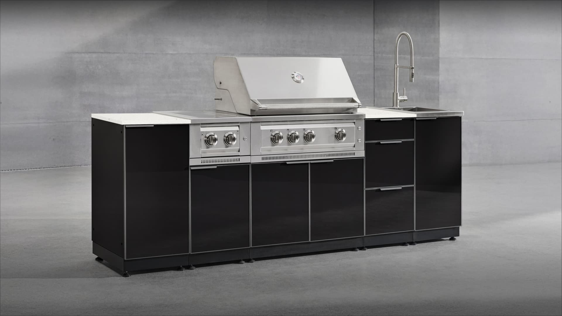NewAge modular grill island in gloss black with a white countertop, built-in gas grill, side burner and sink