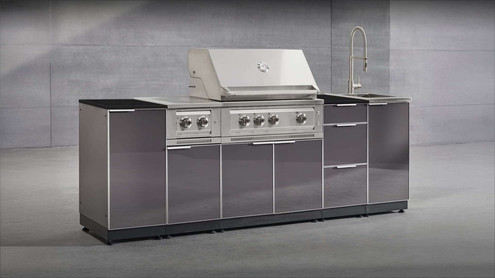 NewAge modular grill island in gloss grey with a black countertop, built-in gas grill, side burner and sink