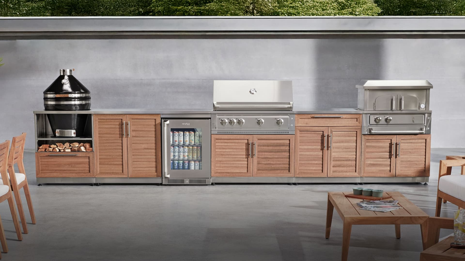 NewAge outdoor kitchen with stone-clad surrounds, a kamado grill and built-in gas grill