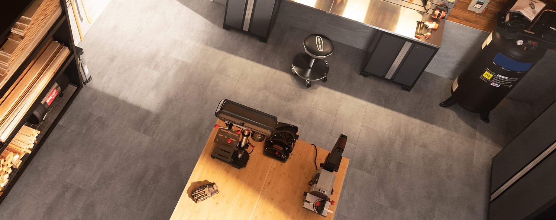 Workshop from above: lumber rack, workbench with power tools, wall cabinets, gray tile