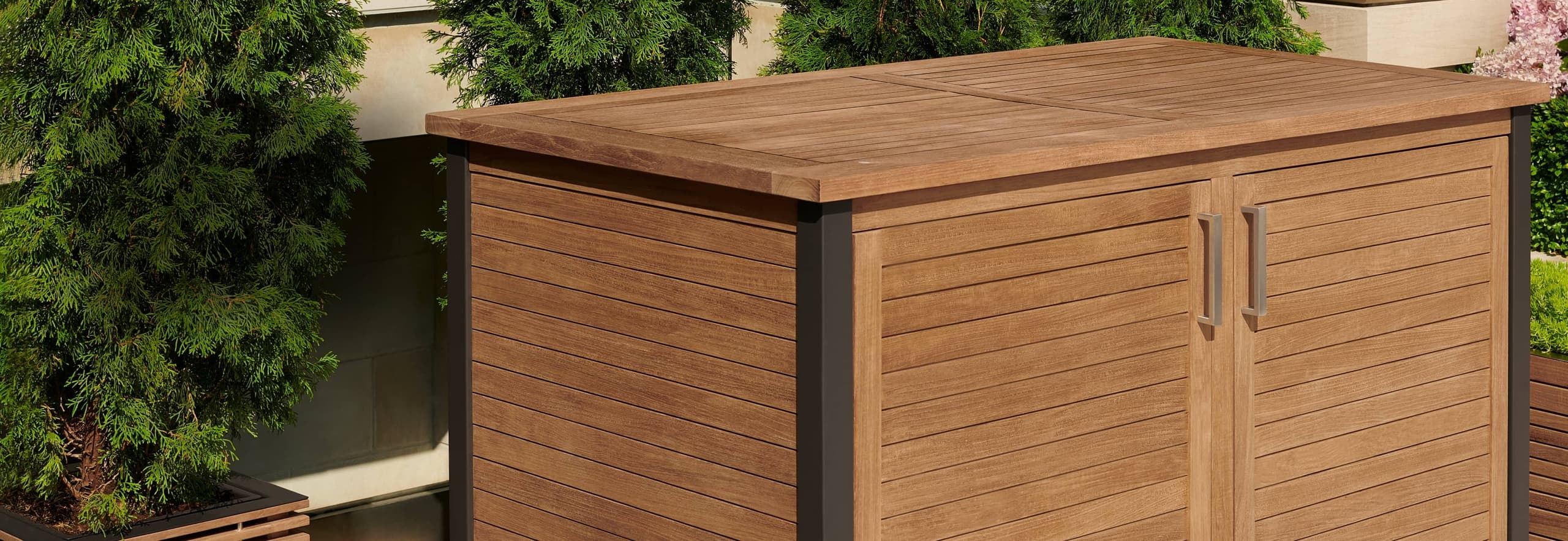 Teak deck box with dark corner accent trim posts on a patio